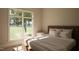 Bright bedroom featuring a large window with views of a tree-lined backyard at 403 Carolyn Ct, Cary, NC 27511