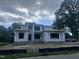 Two-story home under construction with exposed studs and covered in Sagebuilt Home Guard wrap, showcasing modern design at 403 Carolyn Ct, Cary, NC 27511