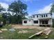 New construction home framed with Sagebuilt wrap and open window frames with a large trees on spacious lot at 403 Carolyn Ct, Cary, NC 27511