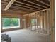 New construction with wooden framing showcases an open layout with window view of leafy yard at 403 Carolyn Ct, Cary, NC 27511