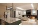 Open-concept living room with modern kitchen, sleek fireplace, and stylish furnishings at 403 Carolyn Ct, Cary, NC 27511