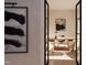 View into a modern office with a wooden desk, comfortable chairs, and stylish artwork at 403 Carolyn Ct, Cary, NC 27511