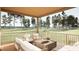 Relax on the covered porch with ample seating and peaceful views of the lush, green lawn at 403 Carolyn Ct, Cary, NC 27511