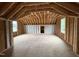 Unfinished attic with exposed wood beams, offering potential for customization at 404 Brodie Rose Landing Way, Smithfield, NC 27577