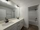 Bathroom featuring double vanity with modern fixtures and access to tub and shower at 404 Brodie Rose Landing Way, Smithfield, NC 27577