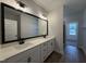 Modern bathroom vanity features double sinks, quartz countertops, and ample cabinet space at 404 Brodie Rose Landing Way, Smithfield, NC 27577