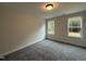 Bright bedroom featuring two windows with views of surrounding greenery at 404 Brodie Rose Landing Way, Smithfield, NC 27577