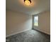 Cozy carpeted bedroom with a bright window offering neighborhood views at 404 Brodie Rose Landing Way, Smithfield, NC 27577