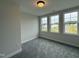 Bedroom with three windows offering a view of the neighborhood at 404 Brodie Rose Landing Way, Smithfield, NC 27577