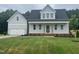 Charming new construction home featuring a welcoming front porch and attached two-car garage at 404 Brodie Rose Landing Way, Smithfield, NC 27577
