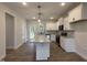 Modern kitchen featuring granite countertops, white cabinetry, and stainless steel appliances at 404 Brodie Rose Landing Way, Smithfield, NC 27577