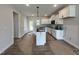 Well-lit kitchen featuring white cabinets, modern black hardware, and a functional island at 404 Brodie Rose Landing Way, Smithfield, NC 27577