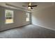 Primary bedroom with ceiling fan, tray ceilings, and large windows offering beautiful views at 404 Brodie Rose Landing Way, Smithfield, NC 27577