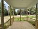 Relaxing porch with wood railings and view of nature at 404 Brodie Rose Landing Way, Smithfield, NC 27577
