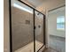 Modern bathroom shower featuring gray tiling, built-in niche, and sleek black hardware at 404 Brodie Rose Landing Way, Smithfield, NC 27577