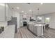 Modern kitchen with gray cabinets, granite countertops, and stainless steel appliances at 509 Donnegal Farm Dr, Fuquay Varina, NC 27526