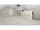 Spacious attic with ceiling fan, natural light, and door for additional storage at 541 Delma Grimes Rd, Coats, NC 27521