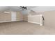 Spacious attic area featuring carpeting, a half wall, and mini split air conditioning at 541 Delma Grimes Rd, Coats, NC 27521