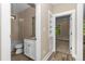Bathroom with tile backsplash, toilet, shower-tub combo, vanity with granite counters and decorative mirror at 541 Delma Grimes Rd, Coats, NC 27521