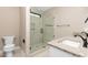 Bathroom with granite counters, glass shower, toilet and tile flooring at 541 Delma Grimes Rd, Coats, NC 27521
