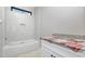 Tiled bathroom featuring a bathtub and granite countertop at 541 Delma Grimes Rd, Coats, NC 27521