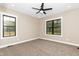 Inviting bedroom with plush carpeting, large windows, and a modern ceiling fan for comfort at 541 Delma Grimes Rd, Coats, NC 27521