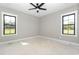 Bright bedroom with two windows and ceiling fan provides natural light and ventilation at 541 Delma Grimes Rd, Coats, NC 27521