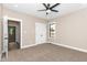 Bright bedroom with plush carpeting, a ceiling fan, and a view into the hallway at 541 Delma Grimes Rd, Coats, NC 27521