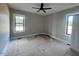 A bedroom features windows and a ceiling fan for natural light and comfort at 541 Delma Grimes Rd, Coats, NC 27521