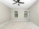 Unfinished bedroom with two windows and ceiling fan provides natural light and ventilation at 541 Delma Grimes Rd, Coats, NC 27521