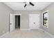 Bright unfinished bedroom featuring a ceiling fan, closet, and natural light from a window at 541 Delma Grimes Rd, Coats, NC 27521