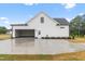 Exterior view of a white, modern farmhouse-style home with a spacious driveway and garage at 541 Delma Grimes Rd, Coats, NC 27521