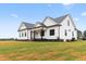 Eye-level exterior view of a white modern farmhouse-style home on a manicured lawn at 541 Delma Grimes Rd, Coats, NC 27521