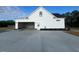 Rear view of home featuring an attached two-car garage and concrete driveway at 541 Delma Grimes Rd, Coats, NC 27521