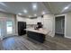 Open kitchen featuring an island, granite counters, stainless appliances, and tile floors at 541 Delma Grimes Rd, Coats, NC 27521