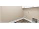 A simple laundry area with white cabinets, wall fixtures, and flooring at 541 Delma Grimes Rd, Coats, NC 27521