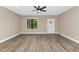 Bright living room featuring wood-look flooring, a ceiling fan, and plenty of natural light at 541 Delma Grimes Rd, Coats, NC 27521