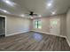 Open living room with luxury tile floors, a ceiling fan and a view of the front yard at 541 Delma Grimes Rd, Coats, NC 27521