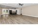 Open concept living space with wood floors, connecting the living room, dining area, and kitchen at 541 Delma Grimes Rd, Coats, NC 27521