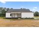 Rear exterior of home with covered porch featuring ceiling fan, and freshly planted landscaping at 541 Delma Grimes Rd, Coats, NC 27521