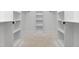 Spacious walk-in closet with white built-in shelving and ample storage space at 541 Delma Grimes Rd, Coats, NC 27521