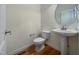 Simple bathroom with pedestal sink and toilet at 5621 Voorhees Ln, Holly Springs, NC 27540