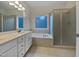 Clean bathroom with double vanity, garden tub, and shower at 5621 Voorhees Ln, Holly Springs, NC 27540