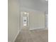 Clean carpeted hallway with access to bedrooms and bathroom at 5621 Voorhees Ln, Holly Springs, NC 27540