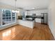 Kitchen with white cabinets, granite countertops and island at 5621 Voorhees Ln, Holly Springs, NC 27540