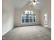 Large main bedroom with a vaulted ceiling and large windows at 5621 Voorhees Ln, Holly Springs, NC 27540