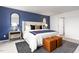 Bright bedroom featuring a comfortable bed and an accent wall at 6012 Sodium St, Raleigh, NC 27610