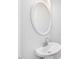 Modern bathroom with a stylish sink and a sleek, round mirror at 624 S Eighth St, Mebane, NC 27302