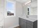 Bathroom with a grey vanity, and a shower with marble tiling at 624 S Eighth St, Mebane, NC 27302