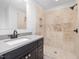 Bathroom with a granite countertop and a tiled walk-in shower with a niche at 624 S Eighth St, Mebane, NC 27302